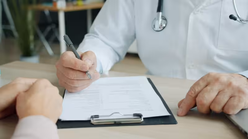 Access on the Ground Floor: A doctor and patient during a consultation Doctor and patient consultation for Access on the Ground Floor - Hearing First Oxford Appointment Status Tracker