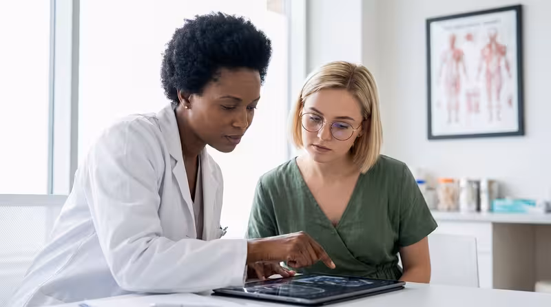 Nearby Bus Stops and Public Transport: A doctor and patient during a consultation Doctor and patient consultation for Nearby Bus Stops and Public Transport - Hearing First Oxford Appointment Status Tracker